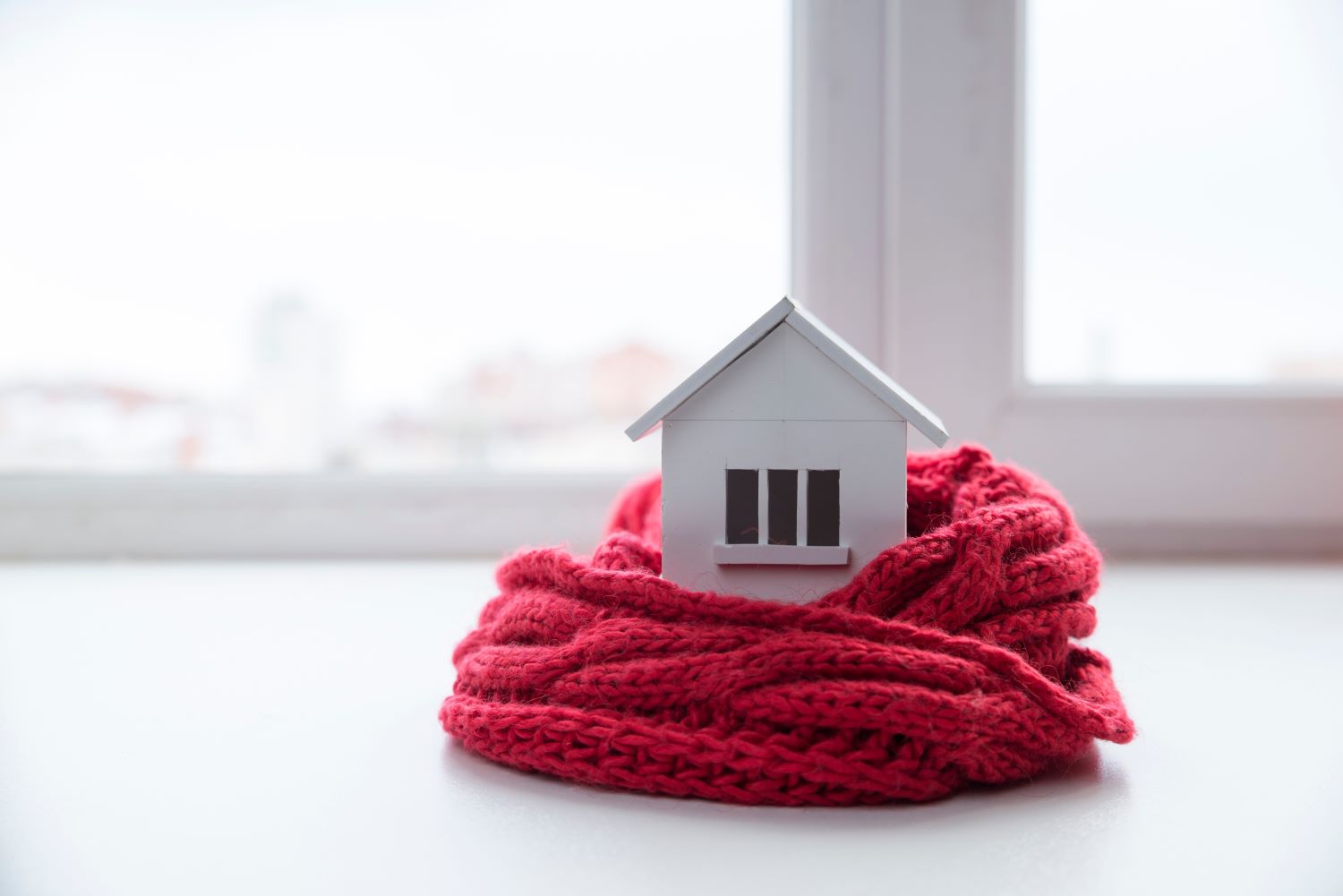 Model home wrapped in red blanket