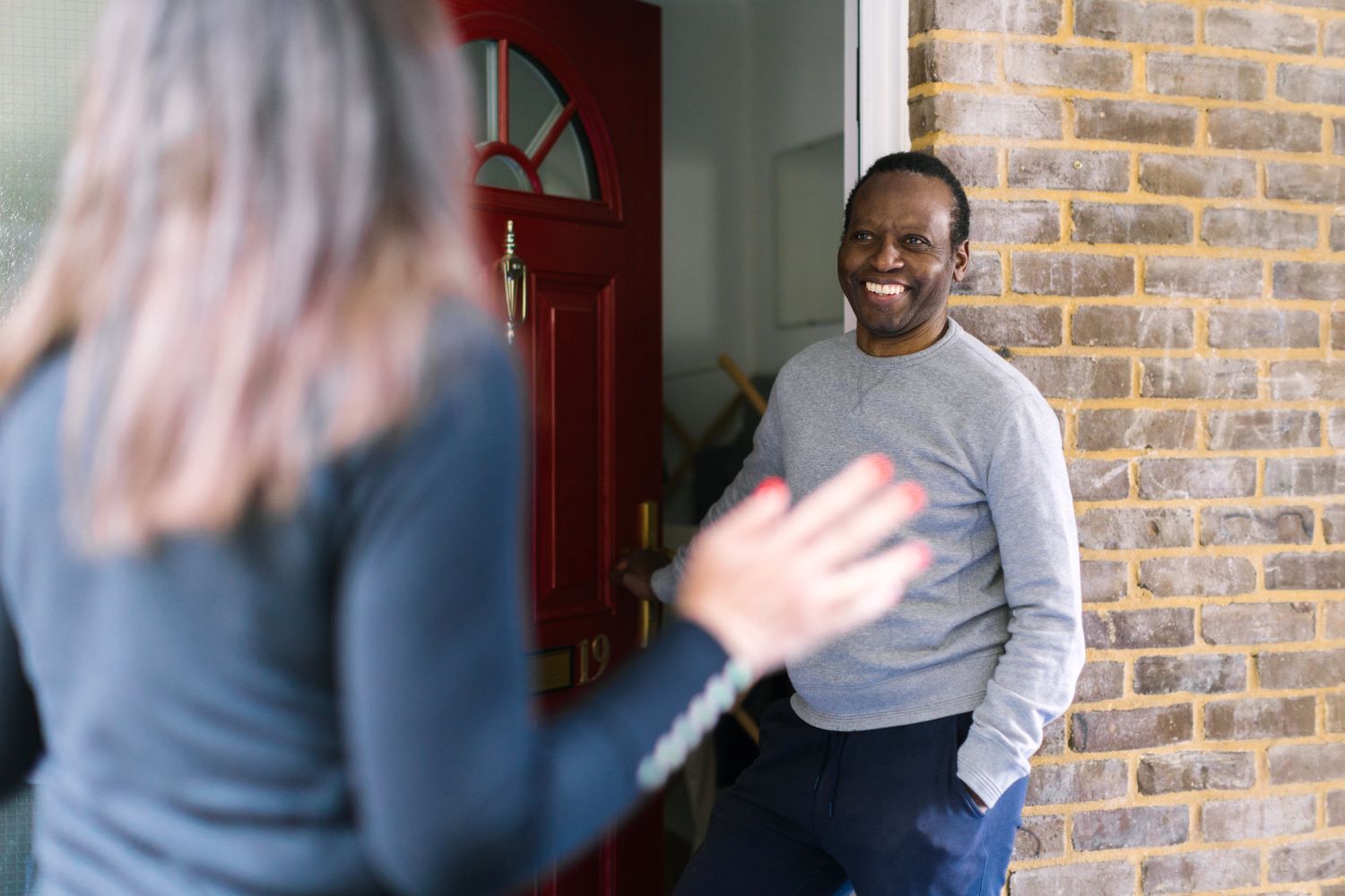 Customer at door smiling at staff