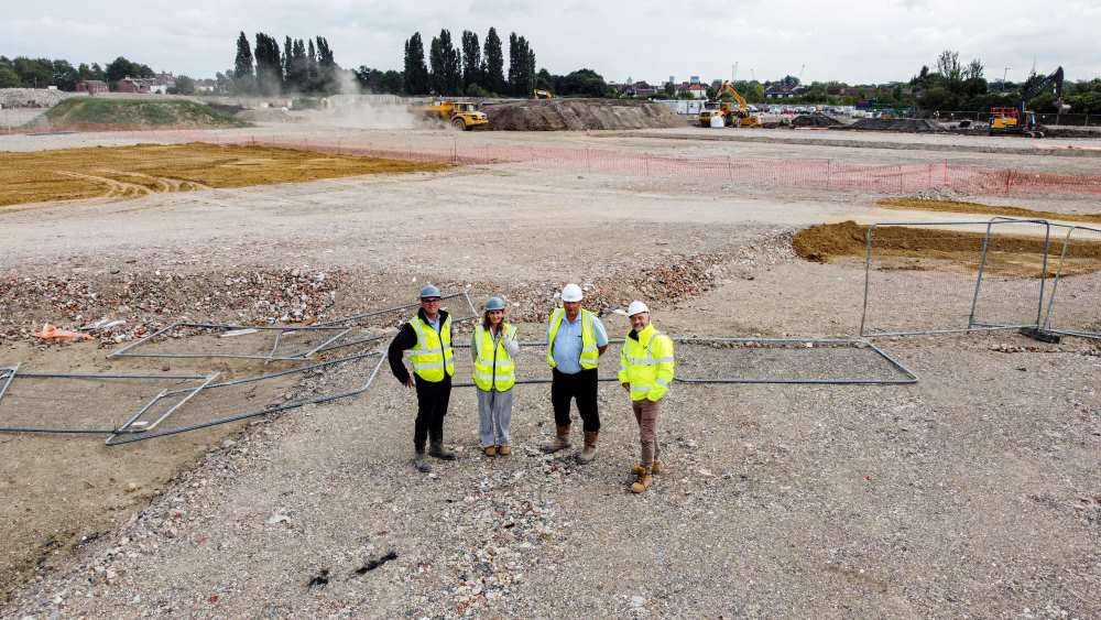 People in high vis jackets standing on Victory Quay site